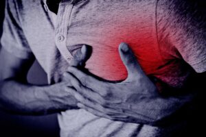 a man holding his heart-area at his chest
